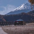 The McLaren GT on a curve in the road with Mt Fuji in the background