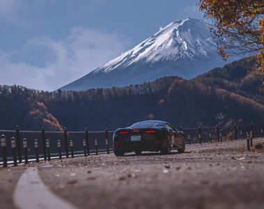 The McLaren GT on a curve in the road with Mt Fuji in the background