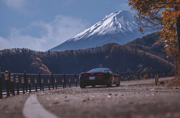 The McLaren GT on a curve in the road with Mt Fuji in the background